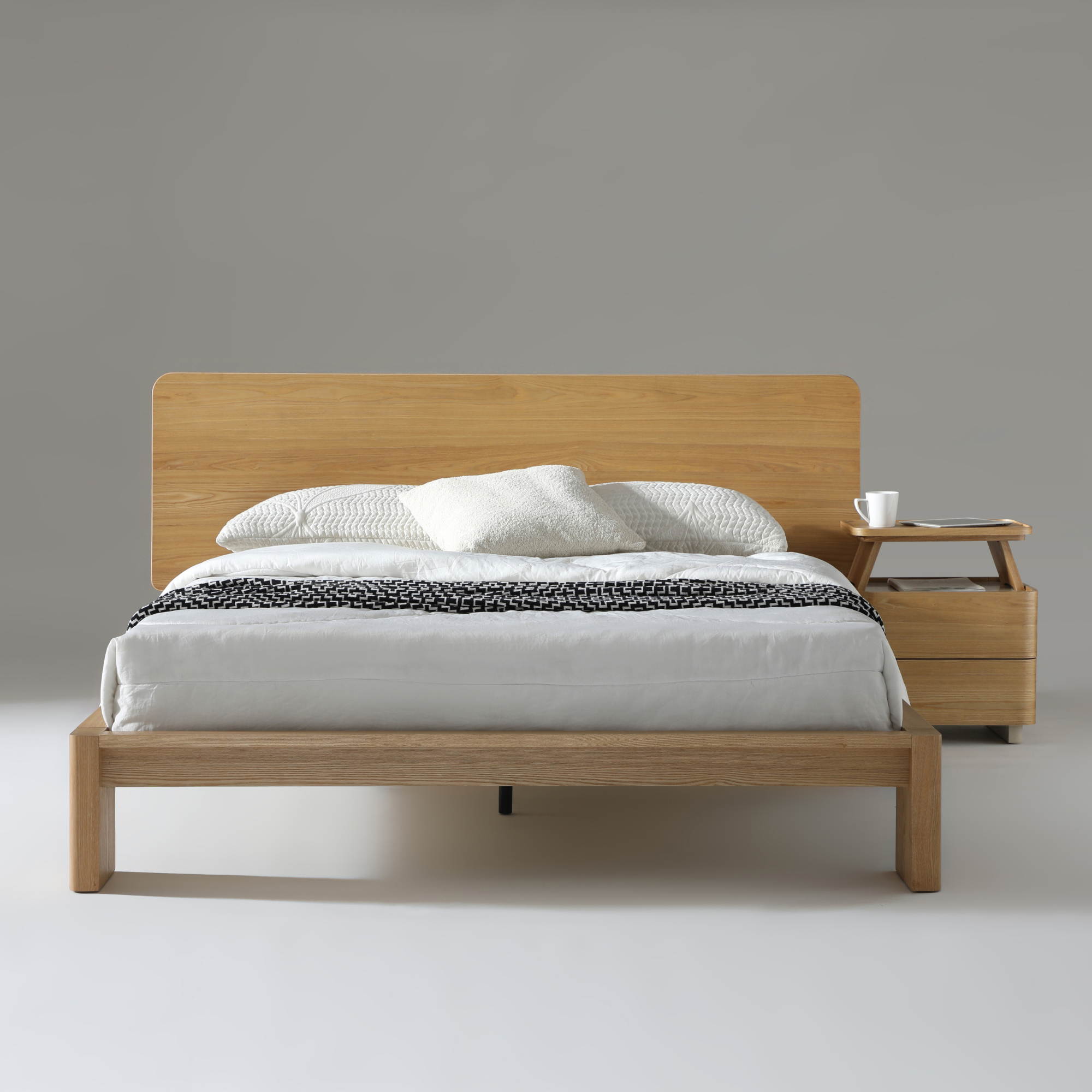 Xara Natural Ash Queen Size Bed with modern design, featuring a natural wood finish, stylish white bedding, and a nightstand.