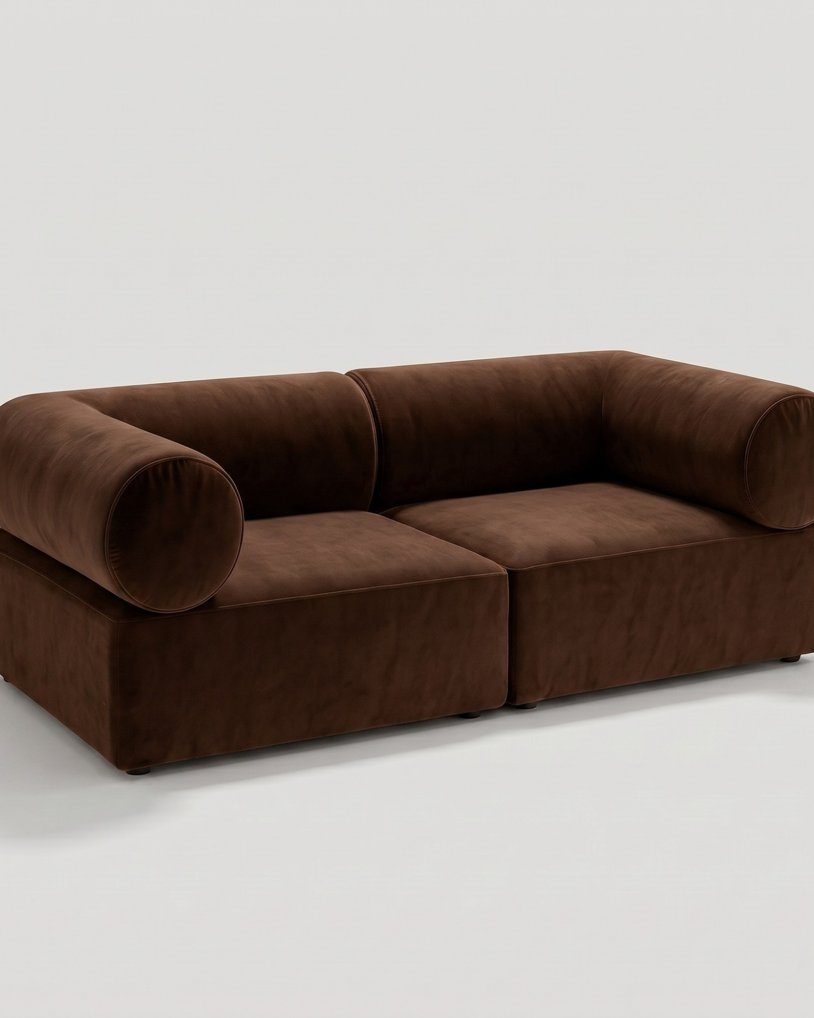 Brown leather sectional sofa with rounded armrests and plush cushions, set against a plain white background for modern living room decor