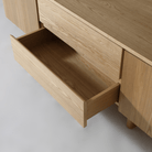 Open drawer of the Kiama 1.8m 2 Door TV cabinet in natural ash, showcasing its sleek design and storage.