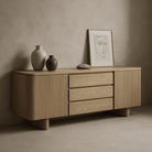 Kiama 1.8m natural ash 2-door entertainment lowline cabinet with modern decor and soft organic edges.