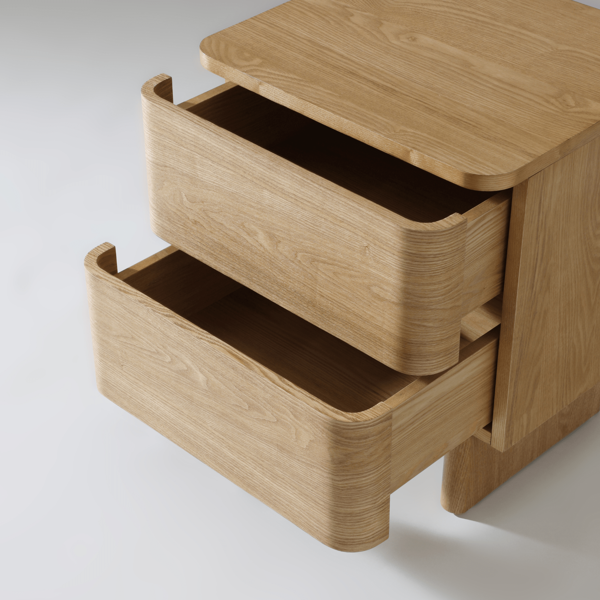 Close-up of Kiama 2 Drawer Bedside Table in natural ash, showcasing its spacious drawers and elegant wood grain finish.