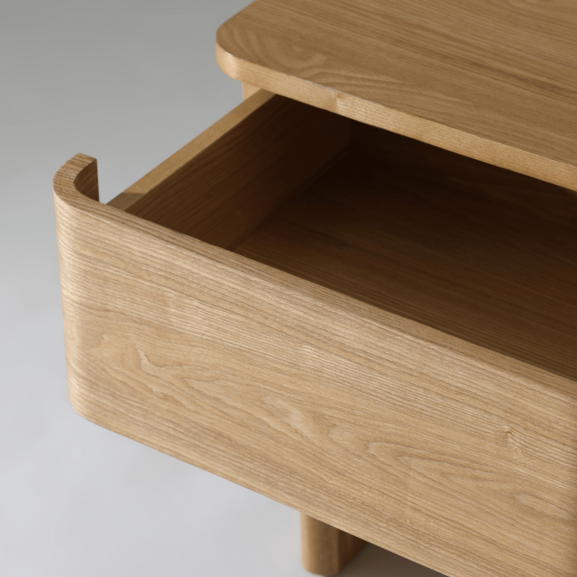 Kiama 2 Drawer Bedside Table in natural ash with an open drawer highlighting its smooth finish and spacious interior.