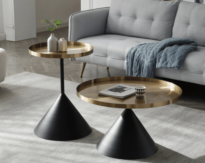 Pair of modern black side tables, 50 cm round metal tray tops, minimalist living room scene with neutral rug, rattan basket, and warm lamplight.