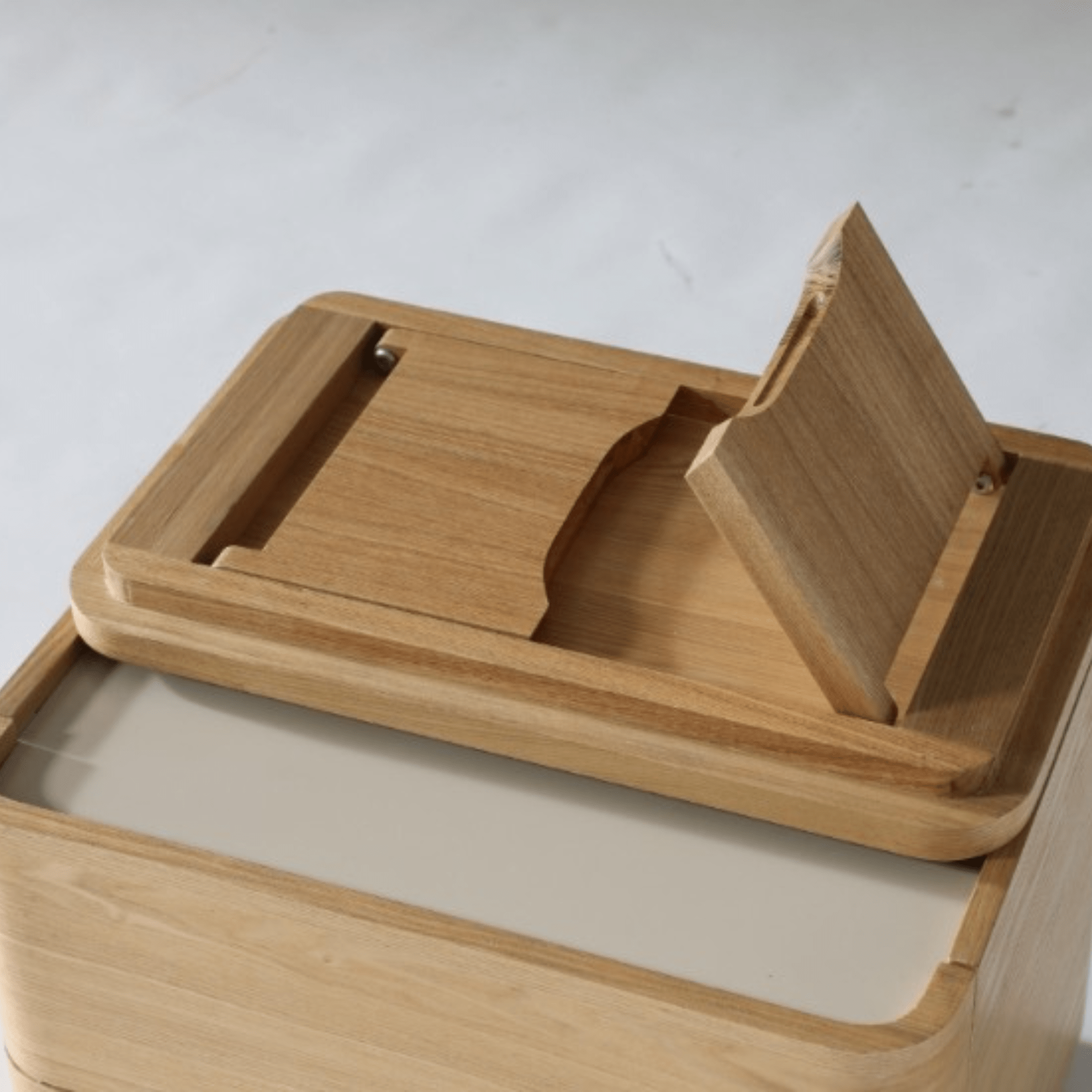 Top view of the Xara bedside table showing natural ash wood finish and a smooth, minimalist design.