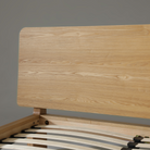 Close-up of Xara natural ash queen size bed headboard showcasing sleek wooden design and grain detail.
