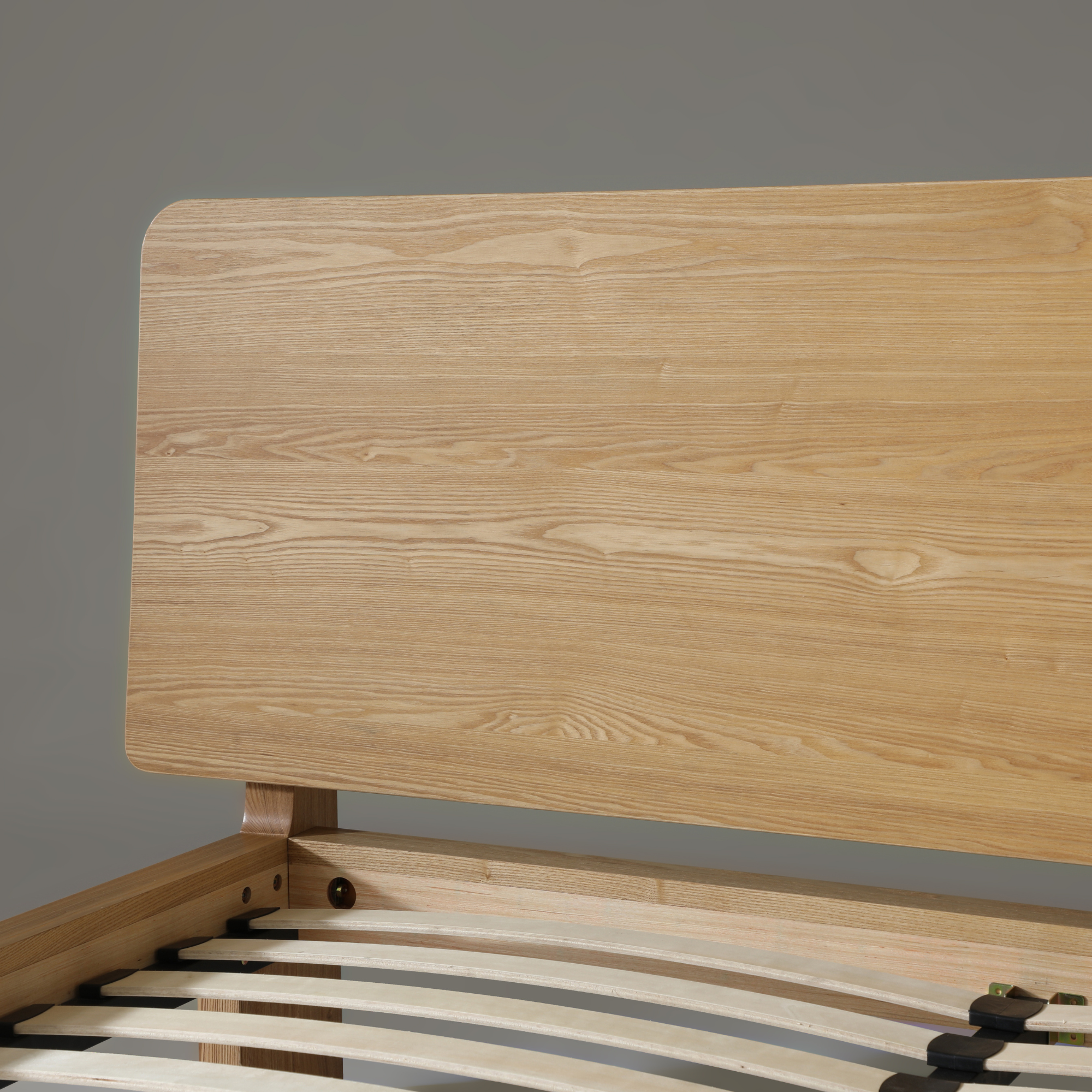 Close-up of Xara natural ash queen size bed headboard showcasing sleek wooden design and grain detail.