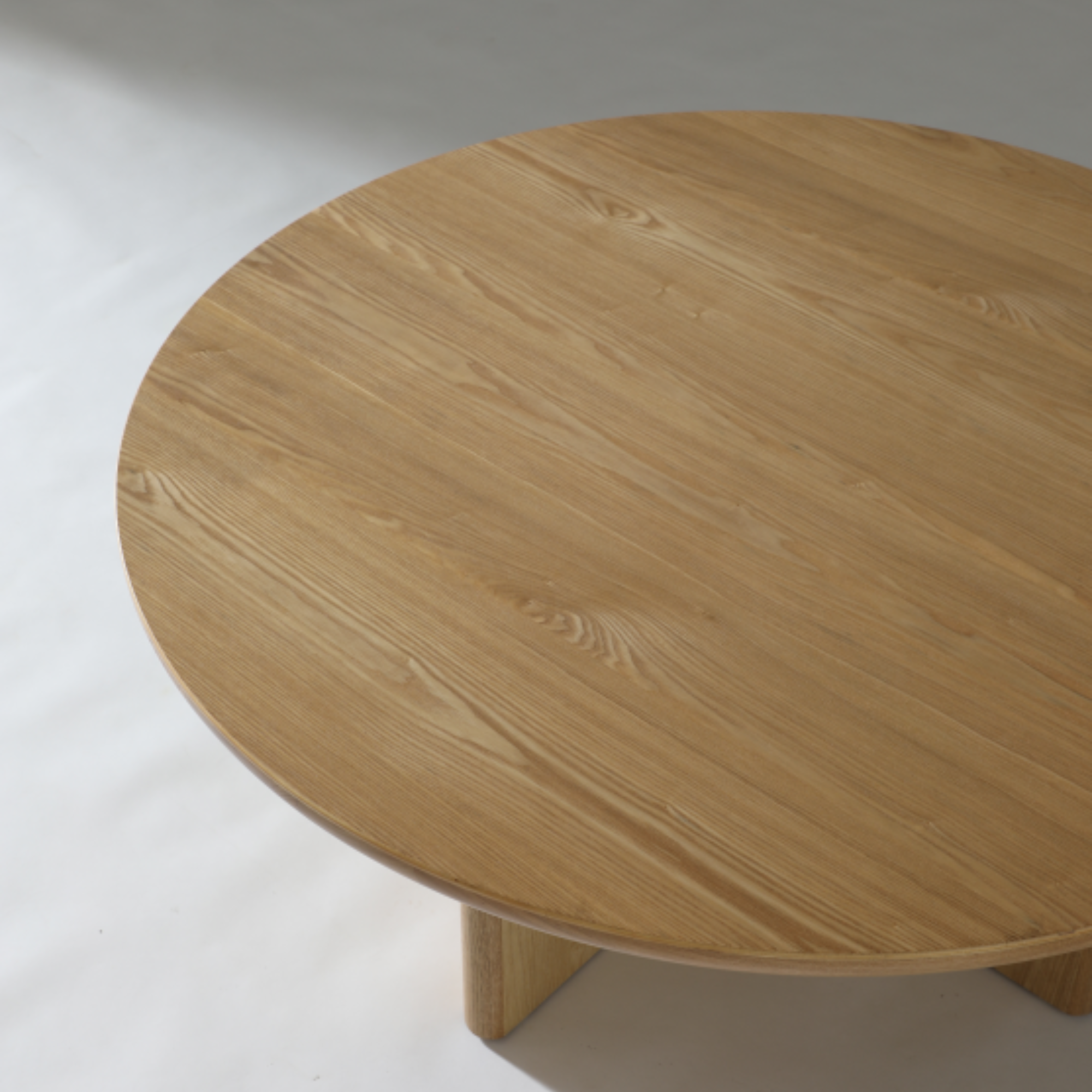 Elegant round coffee table in Natural Ash with light timber tones and clean, organic lines.