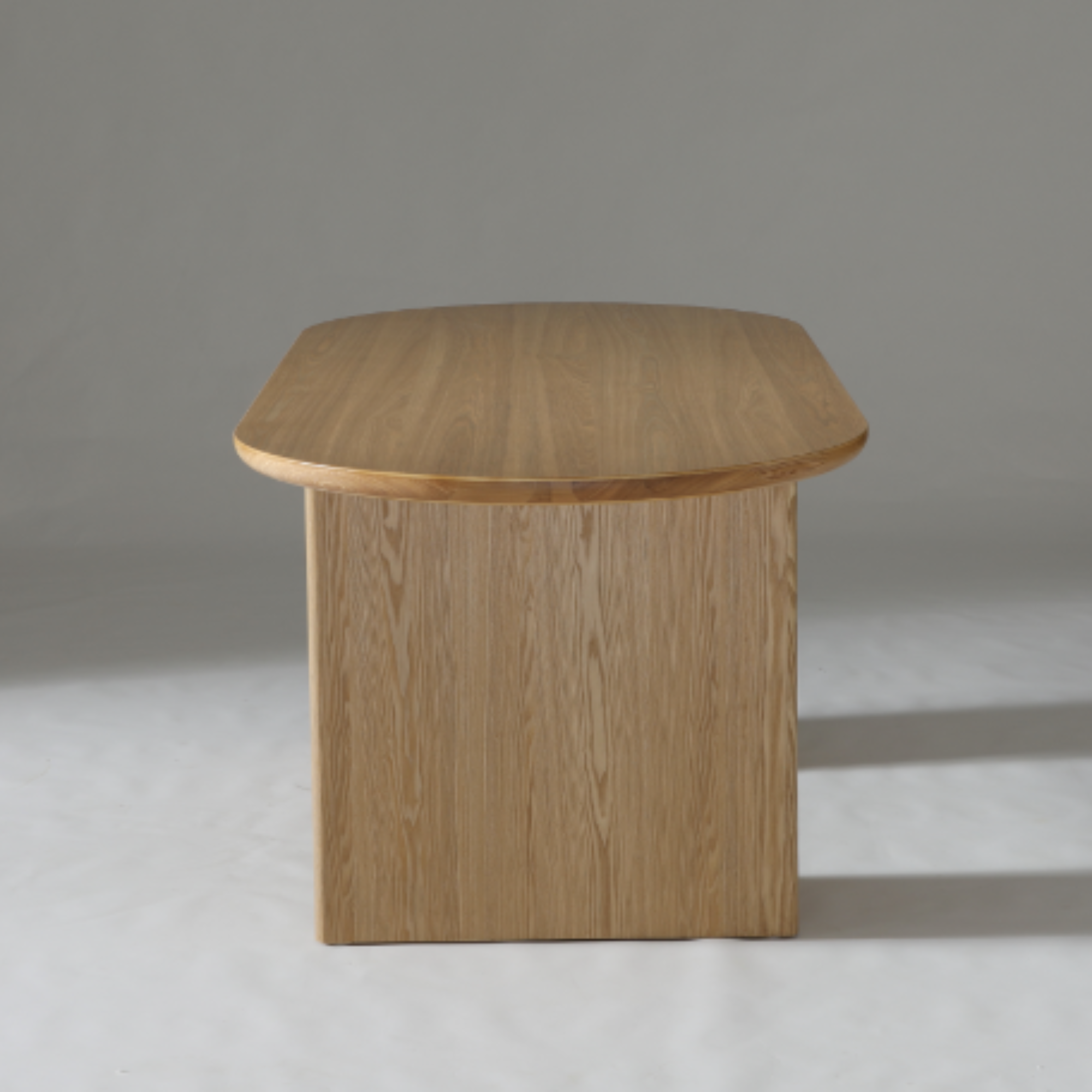 Modern Kiama dining table in Natural Ash, designed with smooth, curved edges and sturdy ash veneer leg frame.

