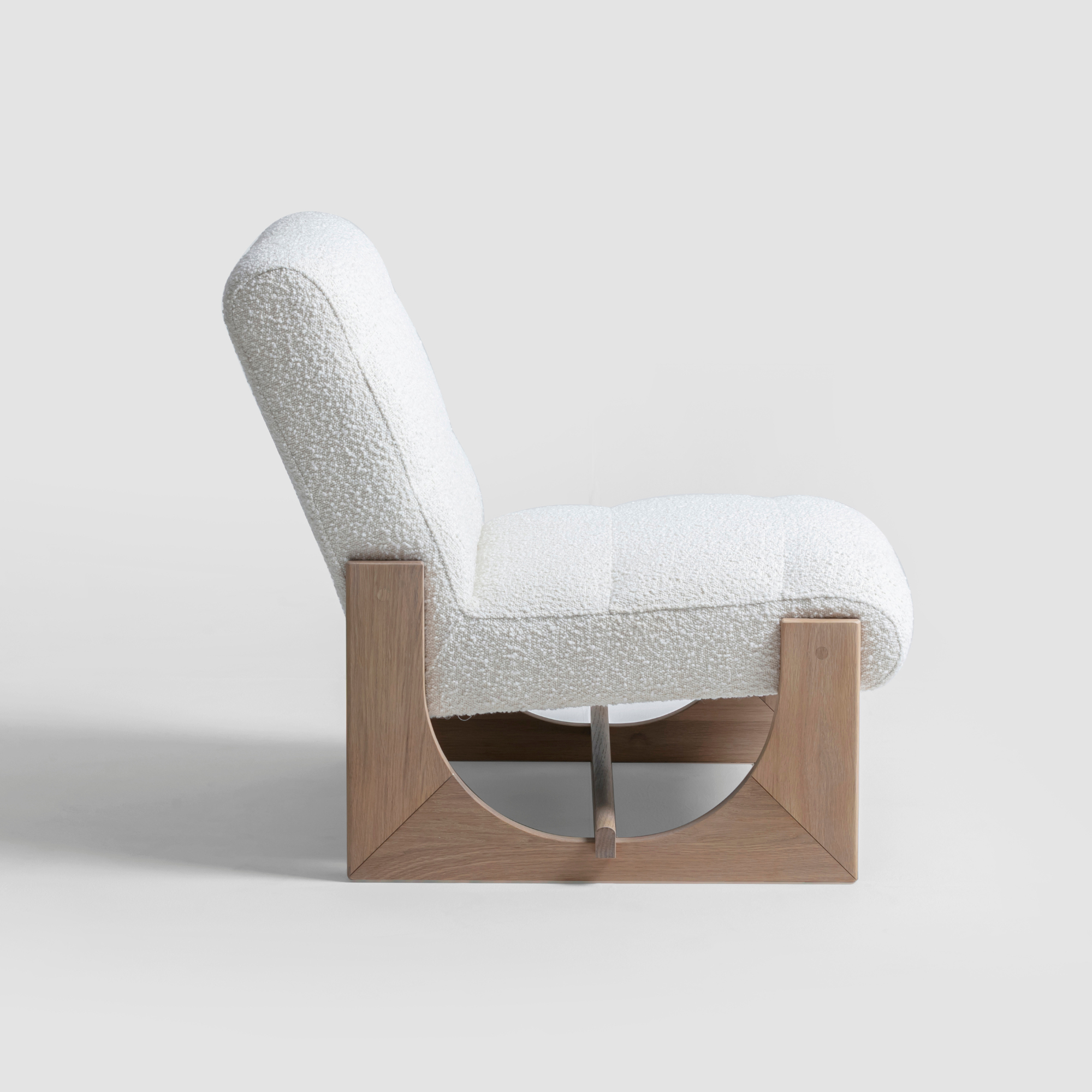 Oscar occasional chair with plush natural boucle seat and curved oak timber arms.