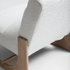 Plush boucle lounge chair with oak timber detailing and minimalist modern design.